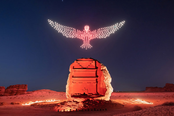 A drawing of a flying falcon above the Tomb of Lyhian Son of Kuza at Hegra, the first UNESCO World Heritage Site in the Kingdom of Saudi Arabia. Hegra’s Drone Light Show explores the origins and beauty of light in its purest form through a performative artwork at the intersection of technology where luminous drones will fly in the dark sky of AlUla to create a flying sculpture accompanied with music.